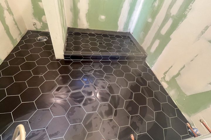Black hexagonal pattern tiles installed for the bathroom floors